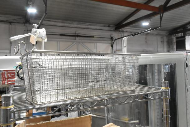 Brand new metal fry basket with minor scratches and dents, stainless steel, mesh design, sturdy handle.