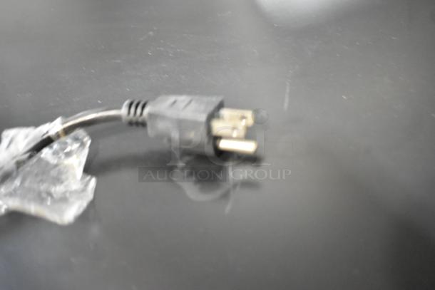 Blurred electrical plug of the Avantco 360SC80 mini cooler, indicating power requirements of 110-120 volts, 1 phase.