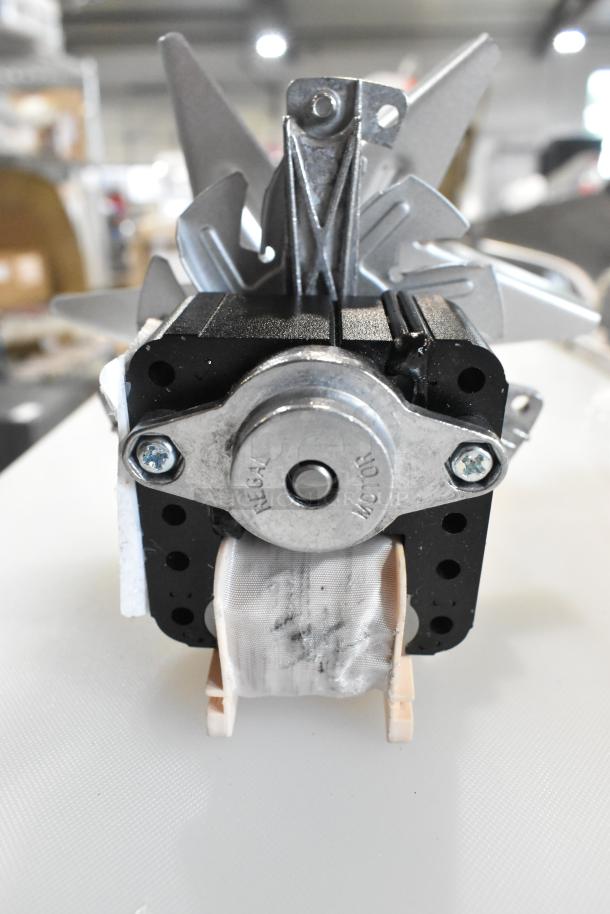 BRAND NEW 2025 Blickman FM-8011 fan motor, minor scratches, visible "REGAL MOTOR" marking on metal casing.