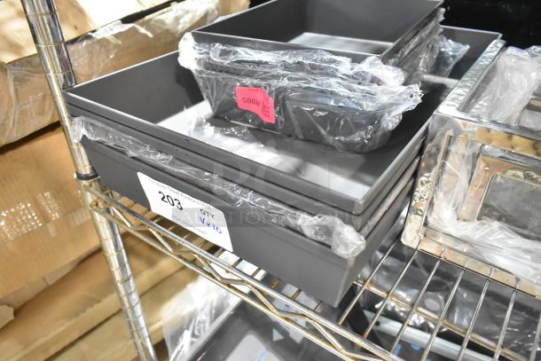 10 new American Metalcraft anodized aluminum Detroit-style pizza pans, 10" x 8" and 17" x 12", on a metal shelf.