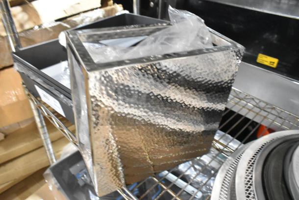 10 brand new scratch and dent items including various American Metalcraft Detroit-style pizza pans and a metal riser on a shelf.