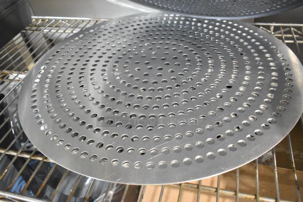 Round perforated baking sheet, metal, appears brand new. Features concentric circular hole pattern. Suitable for baking.
