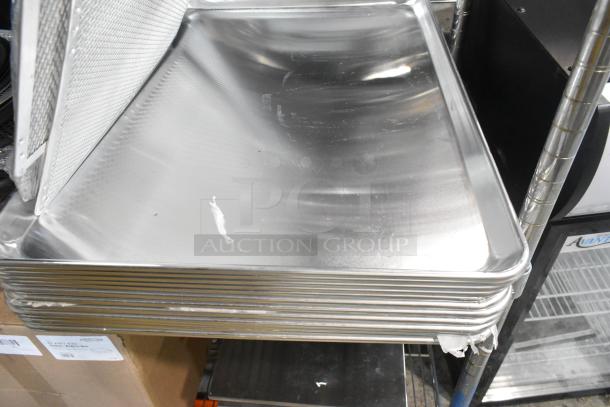 Stack of metal baking pans, including American Metalcraft 11.5" x 9.5" pizza pan separators, new with some dents.