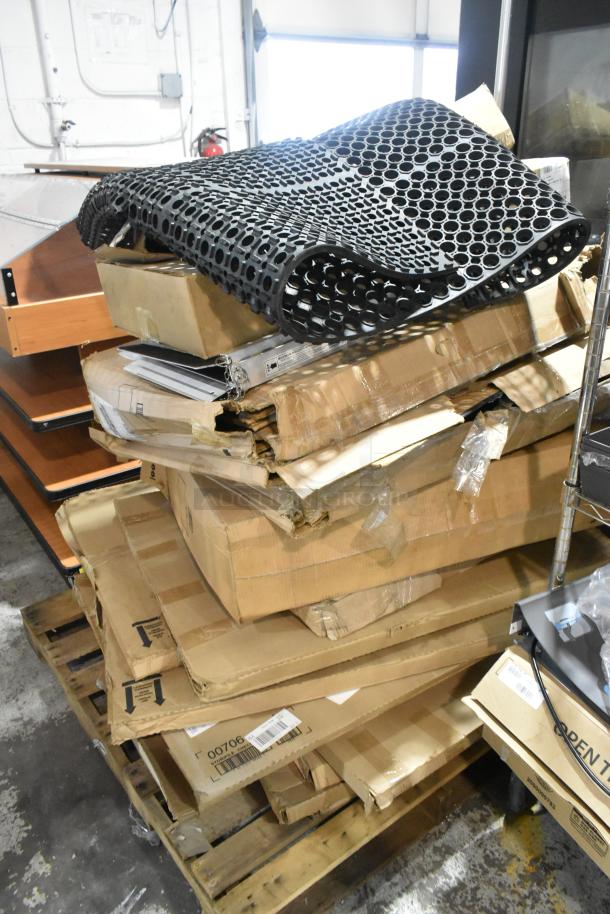 14 brand new scratch and dent items on a pallet, including an anti-fatigue floor mat, storage drawer, and dispenser.