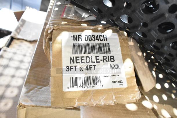 Label on box showing "NR 0034CH Needle-Rib, 3ft x 4ft, Charcoal, Made in Canada." Visible scratch and dent on packaging.