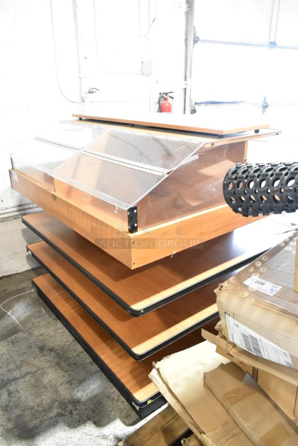 Wood pattern display case merchandiser with multiple tiers, clear front panel, and sturdy wooden frame. Slight wear visible.