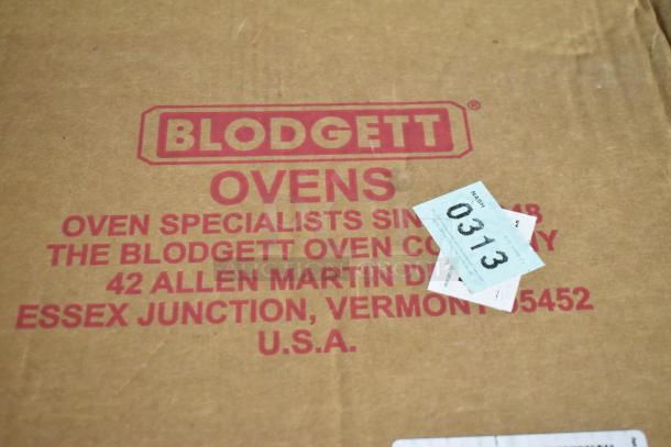 Blodgett vent pieces in original box, marked with company address. Box has scratch and dent, labeled with auction ticket 0313.