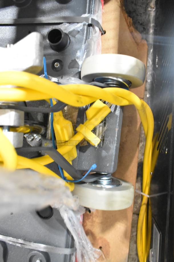 Lavex SP-2805 floor cleaning machine, brand new with minor scratches. Features dual wheels, yellow cords, 120V, 1 phase.