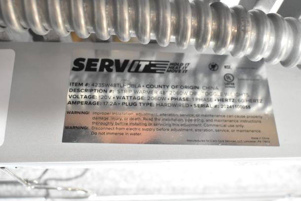 Brand new 2024 ServIt 48" double strip warmer, dual toggle controls, 120V, 1 phase, visible label shows specs and warnings.