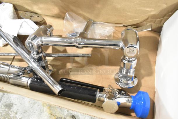 Brand new Fisher 34390 wall-mount pre-rinse faucet in box. Includes 12" wall bracket, 16" riser, 12" swing nozzle, 36" hose.
