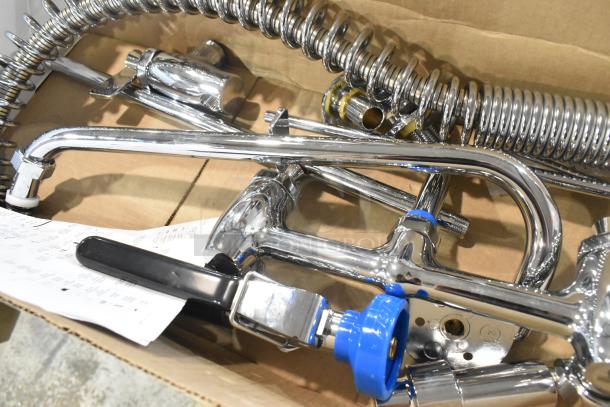 Brand new Fisher 34470 pre-rinse faucet, includes 12" wall bracket, 16" riser, 14" swing nozzle, and 36" hose, minor scratches.