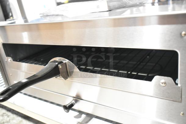 Stainless steel Avantco countertop pizza oven, model 177CPO16TSGL, with adjustable thermostat and broken glass door.