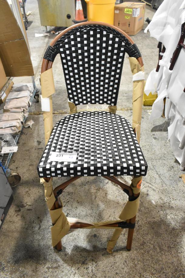 Brand new Lancaster Bistro stool, counter height, black and white checkered weave, rattan material, outdoor use, tags visible.