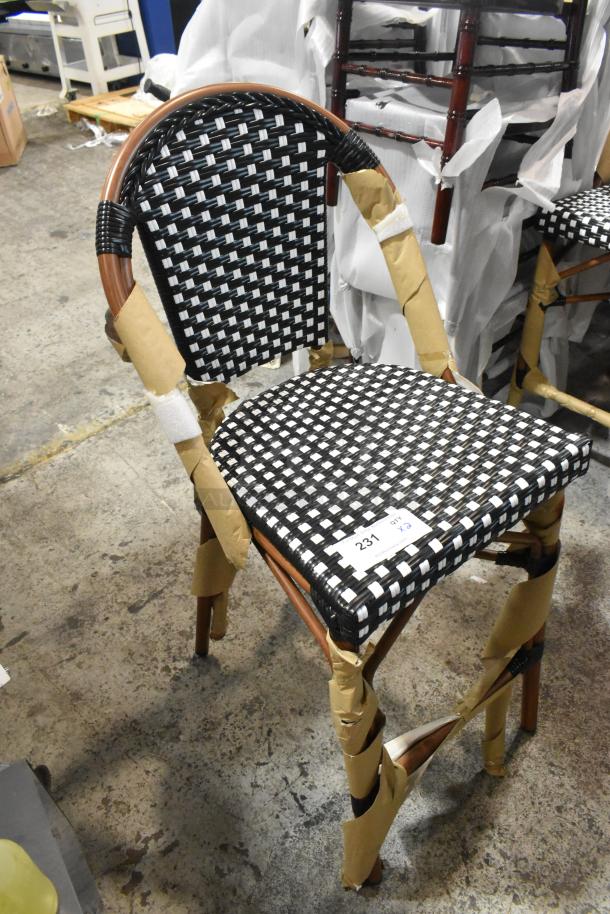 Brand new Lancaster Table & Seating bistro stool, black and white checkered weave, rattan, counter height, tags attached.