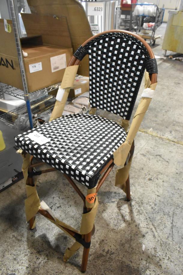 Brand new Lancaster bistro stool with black and white checkered rattan weave, counter height, and protective packaging.