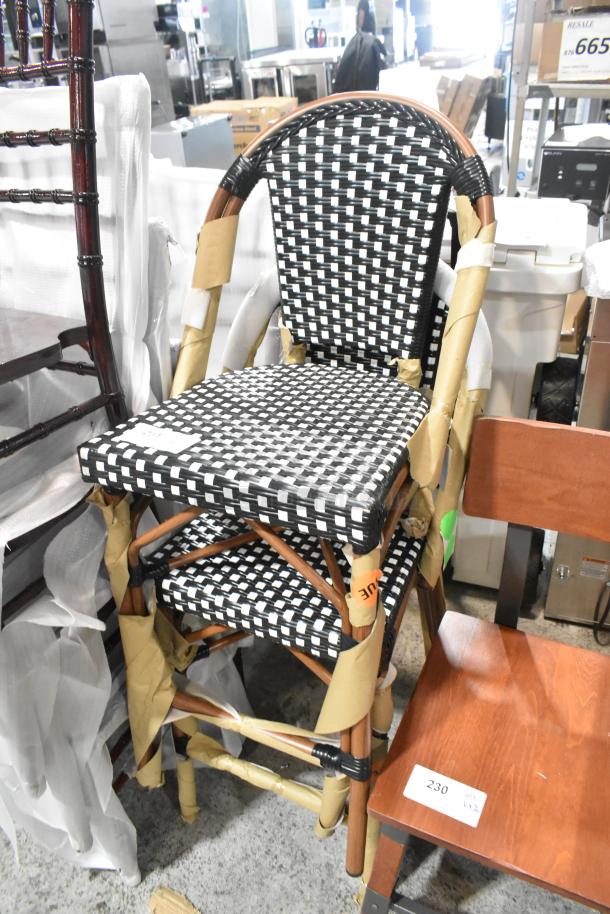 2 new Lancaster Table & Seating bistro stools with black and white checkered weave, rattan frame, counter height, some scratches.
