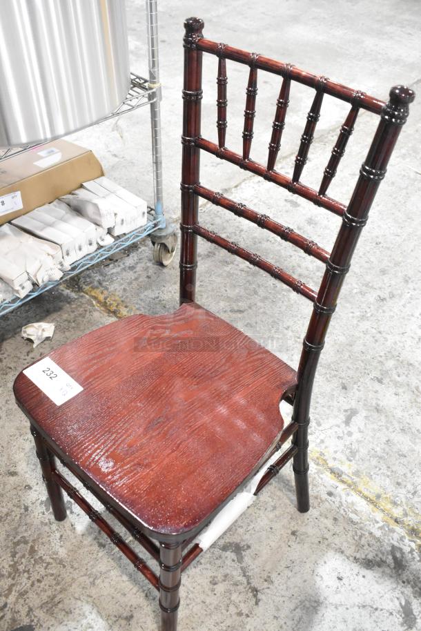 Dining chair with wood pattern, scratch and dent condition. Dark finish, spindle back design, auction tag '232' visible.