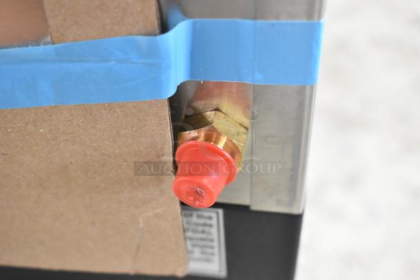 Close-up of a connector on a brand new Bunn VLPF coffee brewer. Wrapped in blue tape, showing factory condition.