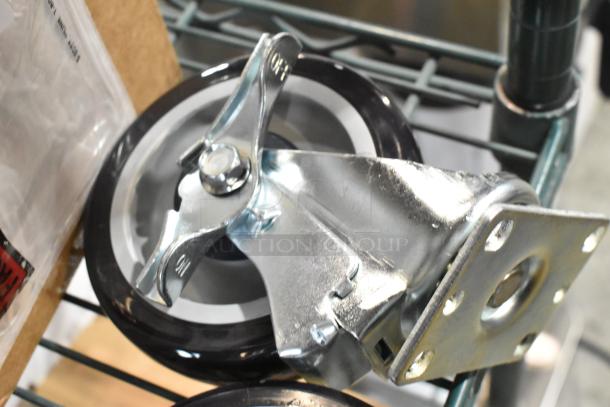 Brand new caster wheel, scratch and dent, with metal frame and mounting plate, part of a lot of 2.
