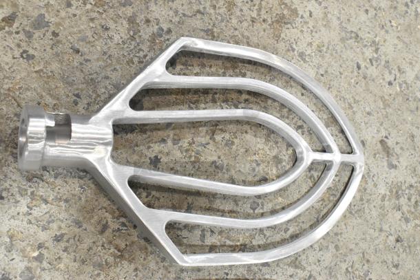 Metal commercial paddle attachment for Hobart mixer, new with minor scratches and dents, durable stainless steel.