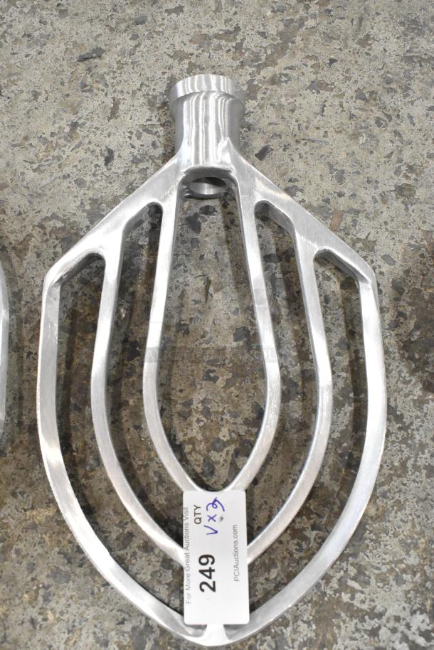 Brand new metal commercial paddle attachment for Hobart mixer, scratch and dent, with label tag indicating auction details.