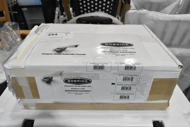 Box of Bobrick B-8876 automatic faucet, polished nickel, counter-mounted with 6 1/2" cast spout, brand new condition.