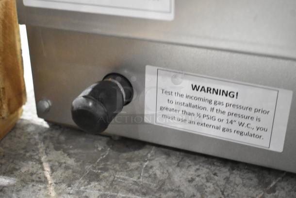 Brand new Carnival King 382DFCG32N fryer, stainless steel, 40 lb capacity, 75,000 BTU, LP/field convertible. Warning label visible.