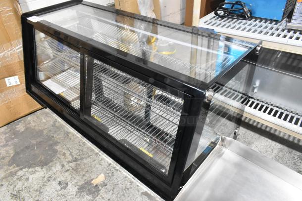 Avantco 360BCSS48HCB 48" black refrigerated bakery display case, LED lighting, scratch and dent, broken glass visible.
