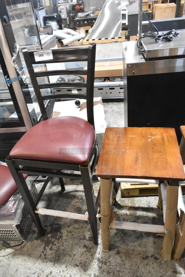 Five new bar height chairs: 4 wooden stools, 1 black metal chair. Visible minor scratches and dents. Auction tag number 266 displayed.