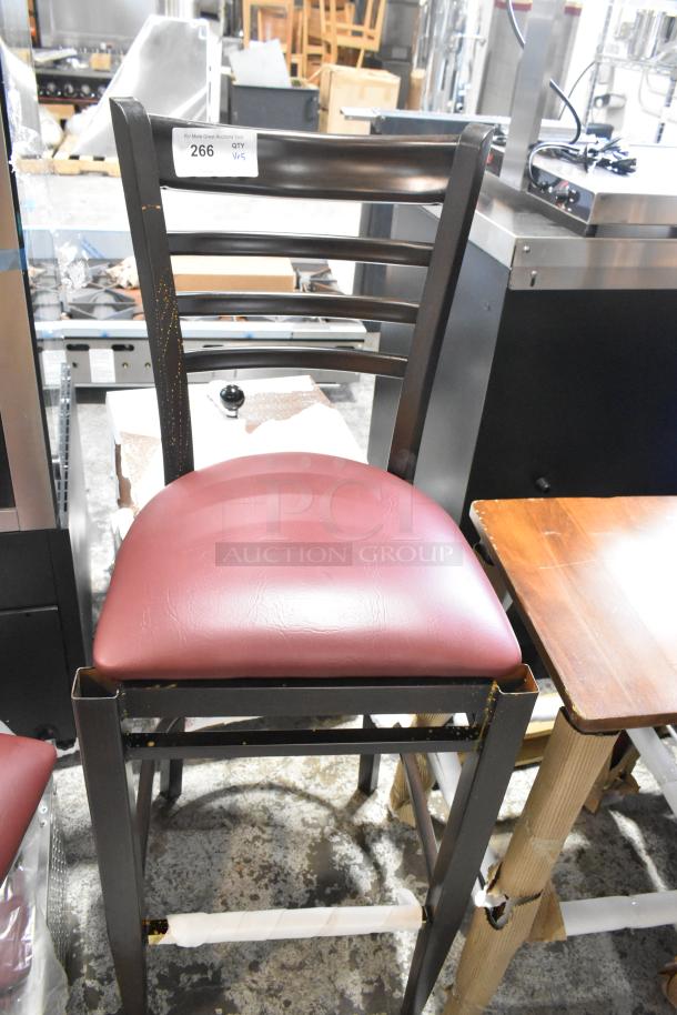 Black metal bar height chair with red cushioned seat, slight scratches; part of a 5-piece scratch and dent set.