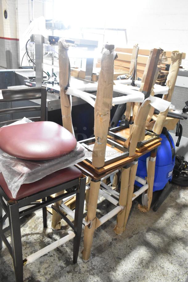 5 brand new scratch and dent items: 4 wooden bar stools, 1 black metal chair, wrapped for protection.