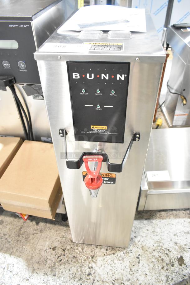 Brand new Bunn H10X-80-240 Hot Water Dispenser, 10-gal, 240V, 1-phase. Stainless steel, warning labels, red tap handle.
