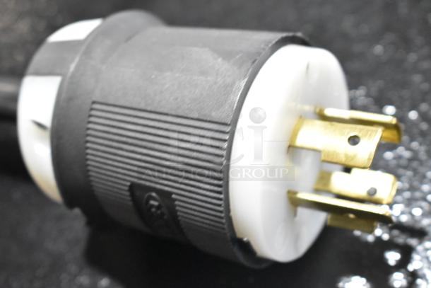 Alt text: Close-up of plug for the 2025 Estella 348CG4 electric cheese grater, showing prongs and a black and white casing.