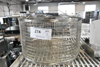 Brand new metal basket with minor scratches and dents, cylindrical shape, mesh design, and visible auction label with number 274.