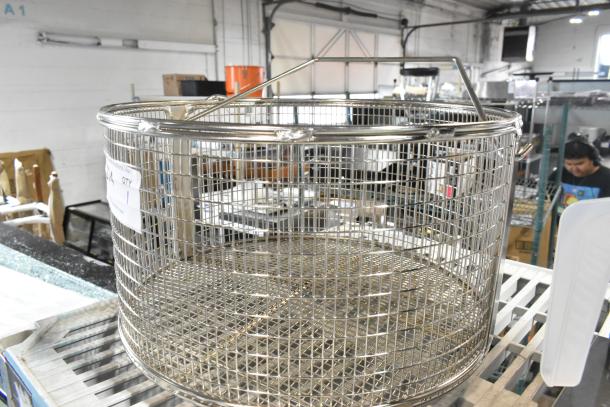 Brand new scratch and dent metal basket, round shape, with sturdy wire construction; visible handling marks on surface.
