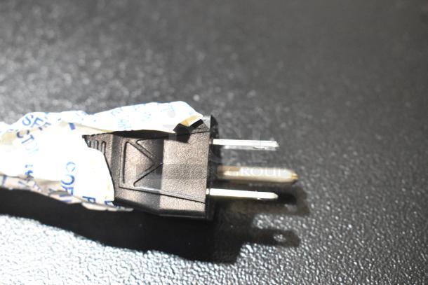 Power cord of Bunn VPR-APS coffee brewer, wrapped in protective paper, showing a standard three-prong plug.
