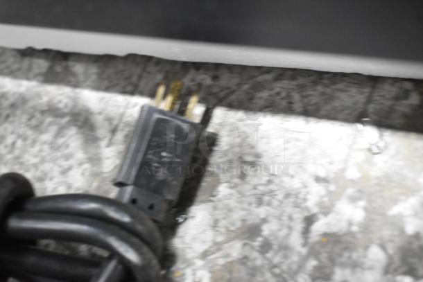 Black power cord for Dough Xpress DXE-W pizza dough press, shown partially blurred. 120 volts, 1 phase.