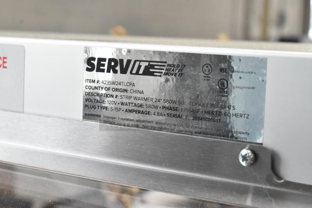 BRAND NEW ServIt 423SW24TLCPA 24" lighted strip warmer. Features 580W, 120V, 1 phase. Tags detail specs and warnings.