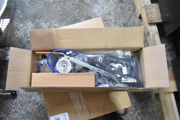 Box containing new Elkay water fountain bottle filling attachment and various parts. Items are scratch and dent.