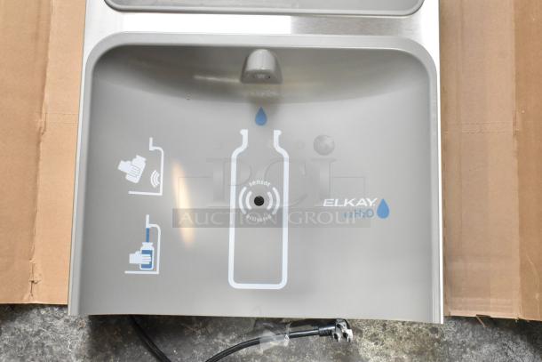 Elkay ezH2O bottle filling attachment, brand new, with scratch and dent. Includes sensor activation and a box of parts.
