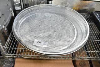 Five brand new metal mesh baking screens on a shelf, each with a round metal pan. Label indicates lot 294, quantity 5.