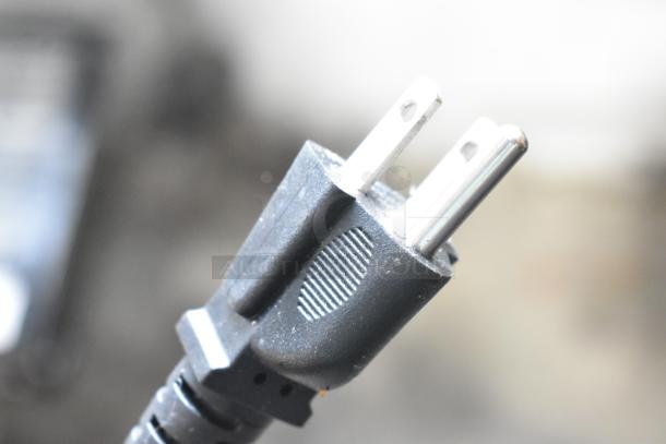 Close-up of a black electrical plug for the Estella 348WBMX1A Stainless Steel Commercial Belgian Waffle Maker.