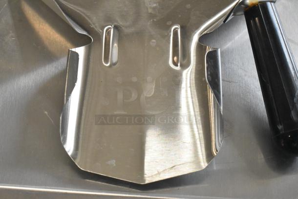 Stainless steel fry scooper, Pro-ware brand, new with minor scratches and dents, features black handle.