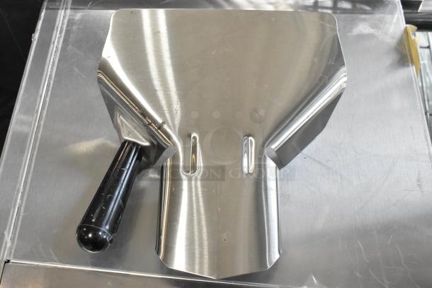 Pro-ware stainless steel fry scooper, new with scratch and dent marks, black handle, durable design.