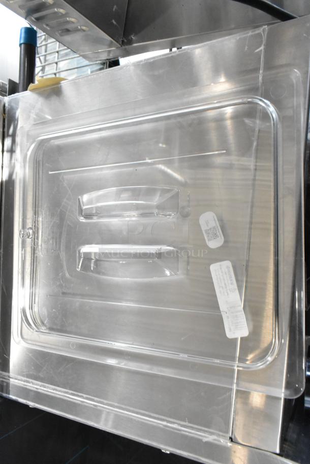 8 new scratch and dent items including Cambro Camwear 1/2 size clear polycarbonate handled lid; labels visible.