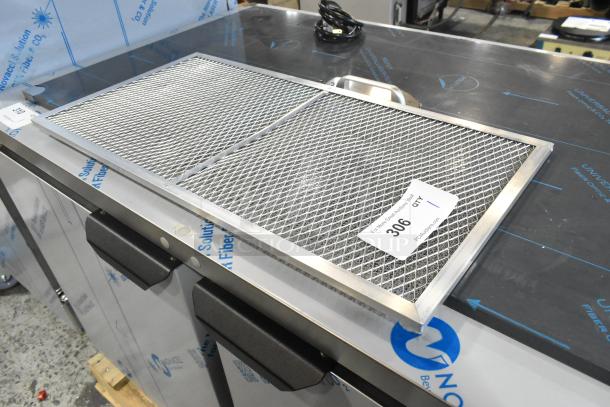 "Brand new metal filter with scratch and dent; mesh design, metal frame, condition label marked '306 qty 1' visible on surface."