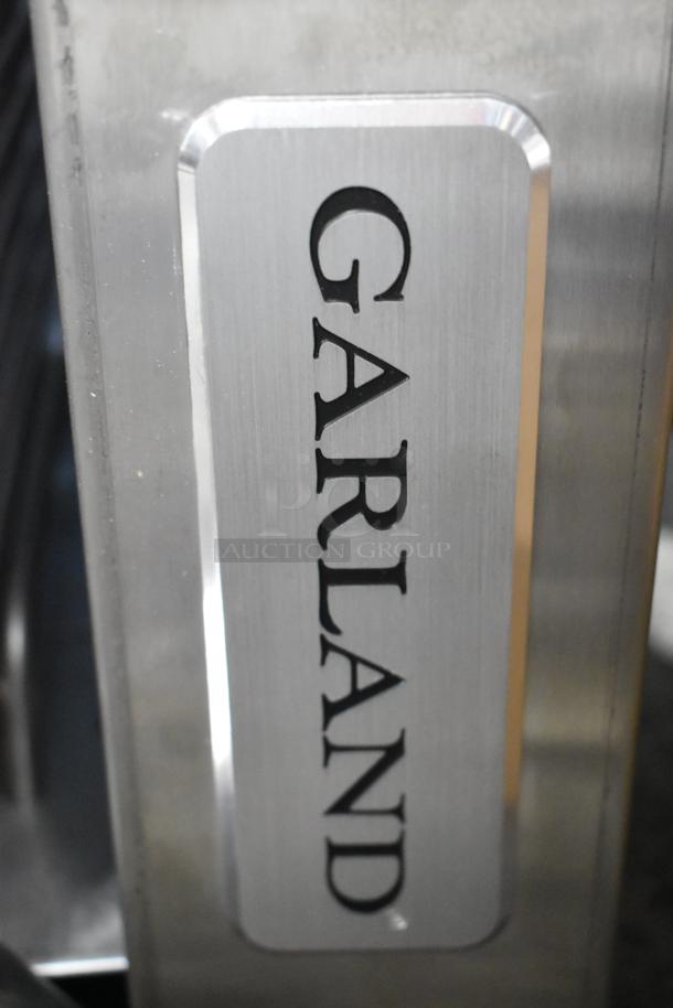 Garland stainless steel cheese melter, natural gas, brand new with scratches and dent, logo visible.