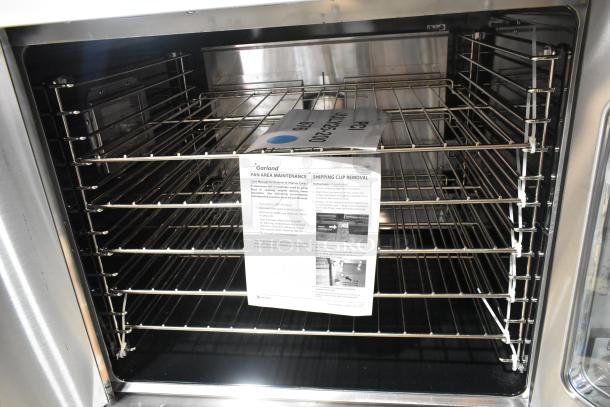 BRAND NEW Garland SUMG-100 stainless steel convection oven, 53,000 BTU, metal racks, thermostatic controls, view-through doors.