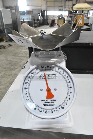 Detecto T25BN countertop scale, brand new with minor scratches, 25 lb capacity, stainless steel top, model T25BN visible.