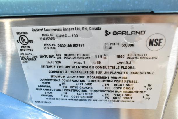 Alt text: Label showing Garland SUMG-100 convection oven details: NSF certified, 53,000 BTU, natural gas, 120V, listed as suitable for combustible floors.